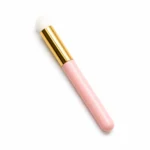 Pink soft-bristled lash cleansing brush for gently deep-cleaning eyelash extensions with foaming lash shampoo.